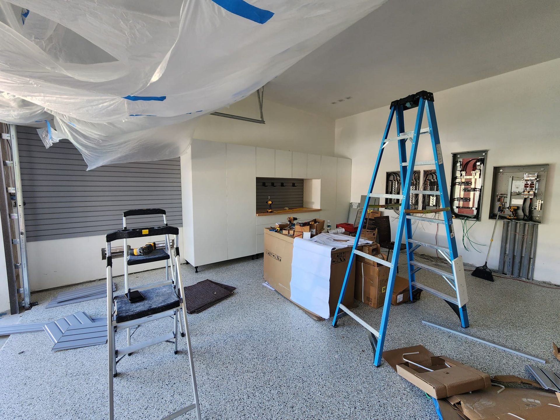 a ongoing white garage project with grey  slatwall 