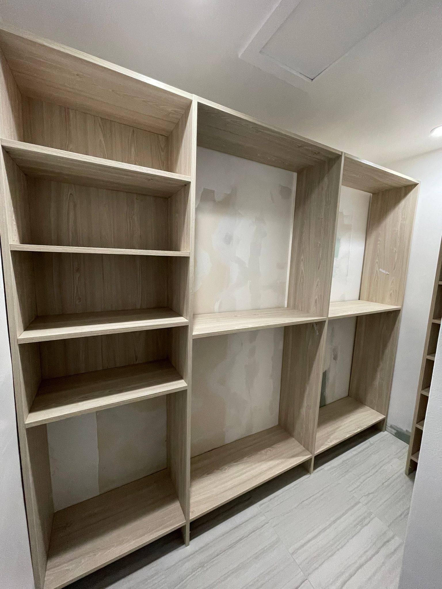 a custom walk-in closets with a lot of shelves