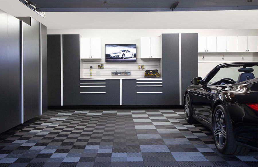 A car is parked in a garage with a checkered floor