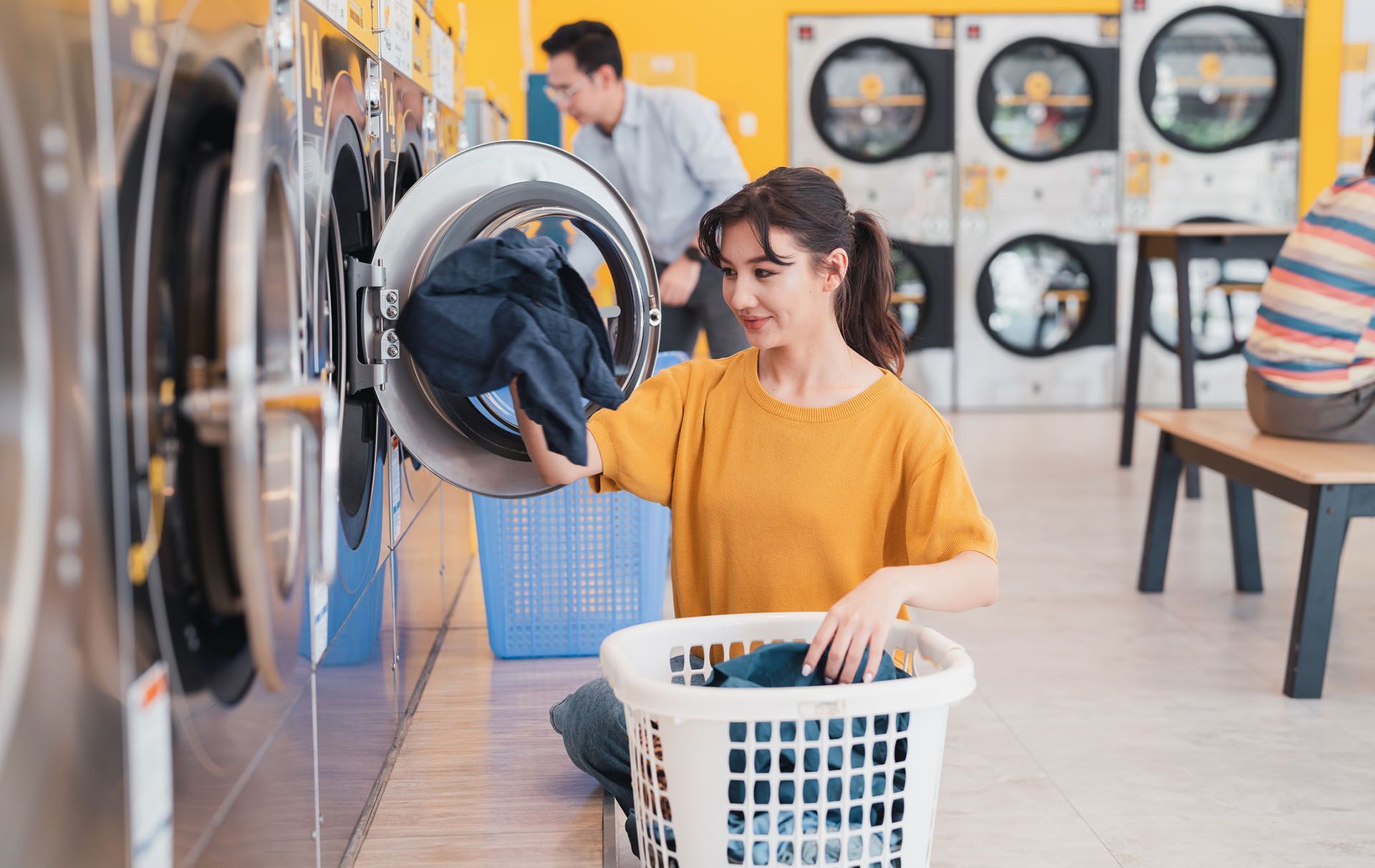 Woman Using a Washing Machine — Beatrice, NE — Soap Opera Laundry