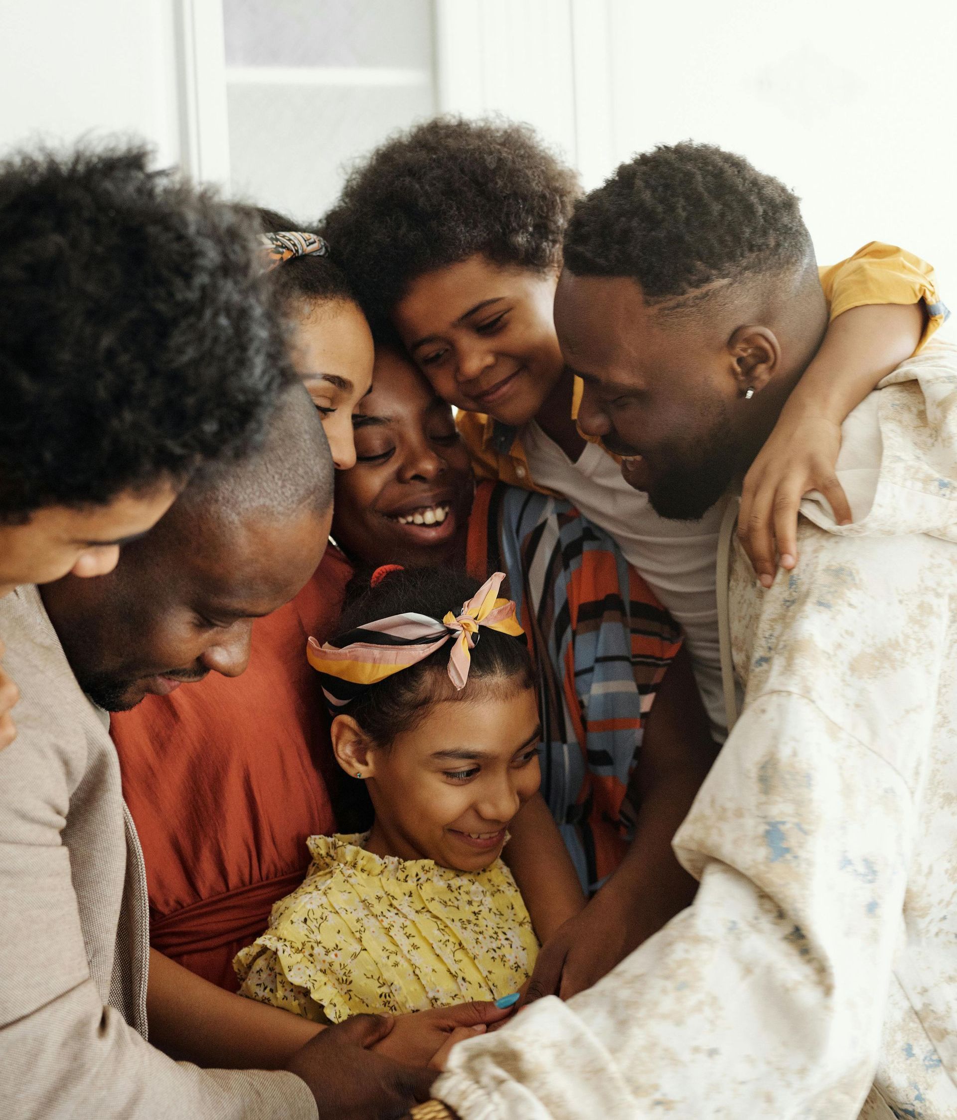 A group of people are standing around a little girl.
