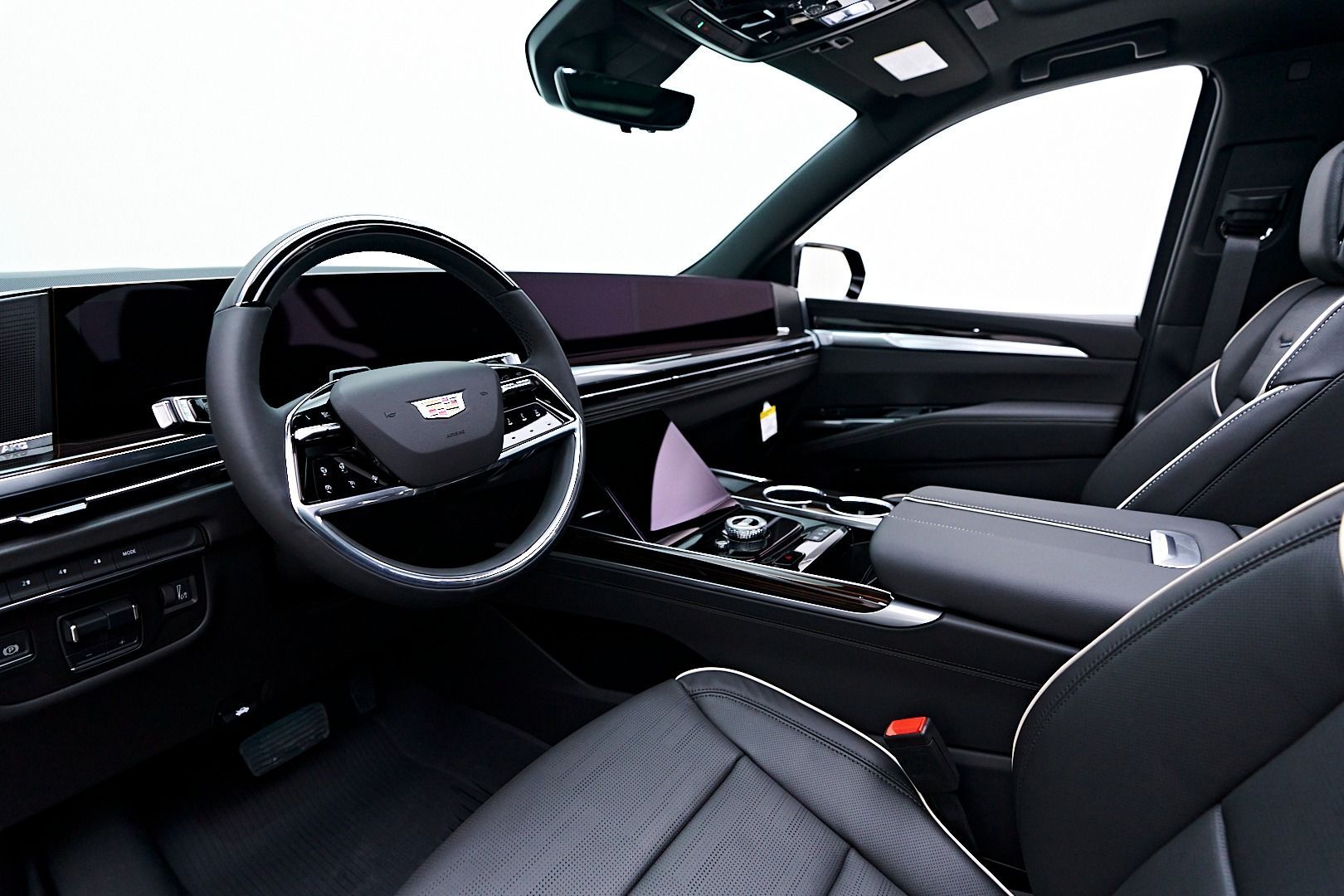 A close up of the steering wheel and dashboard of a car.