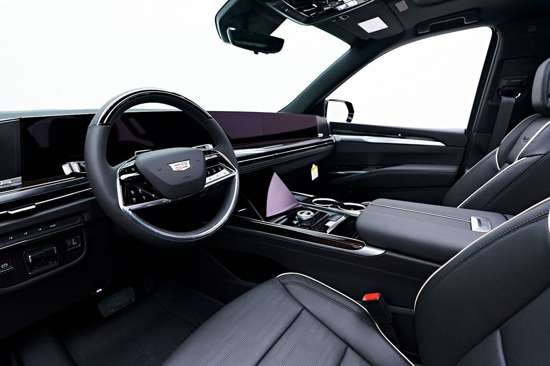 A close up of the steering wheel and dashboard of a car.