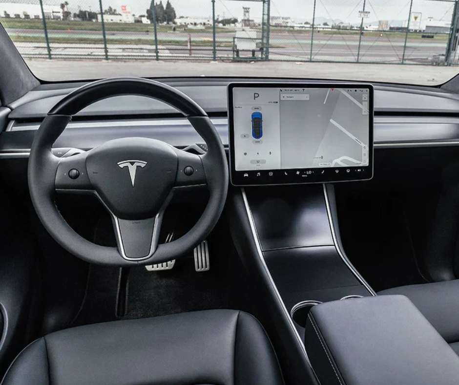 The interior of a car with a sunroof and leather seats.