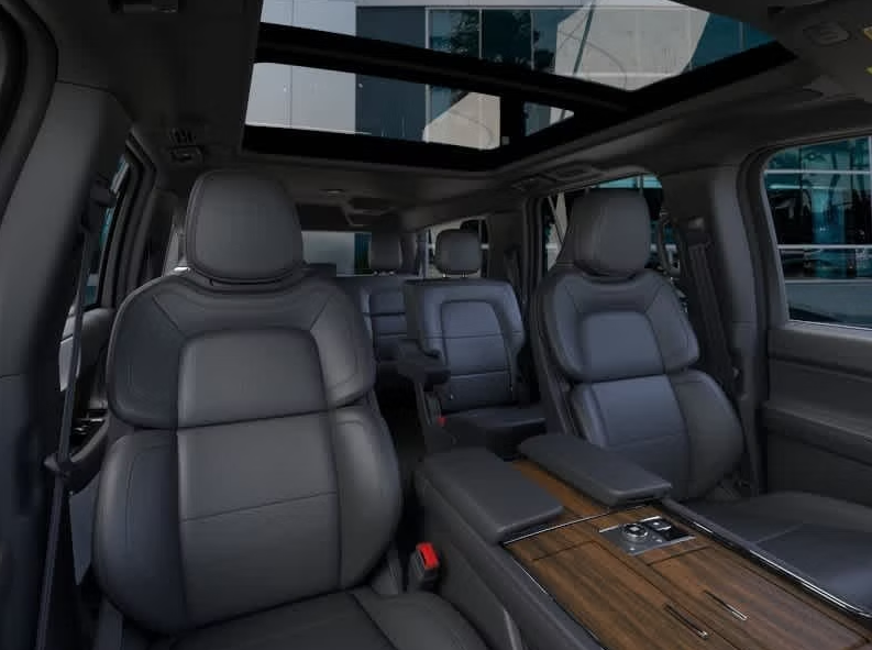 The interior of a car with a sunroof and leather seats.
