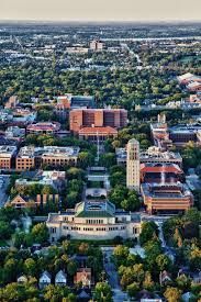 A chair with a yellow pillow and a necklace on it