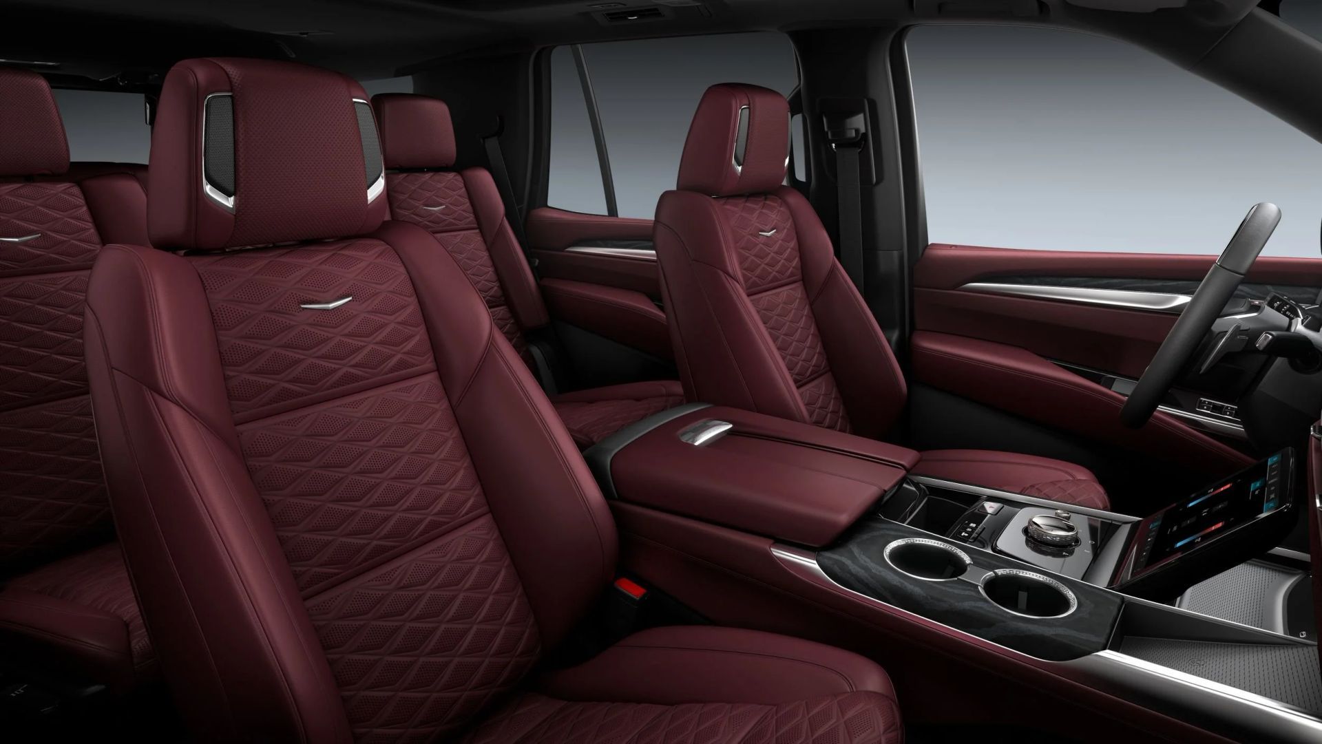 Interior of a luxury car featuring a large, curved display screen, white seats, and wood trim.