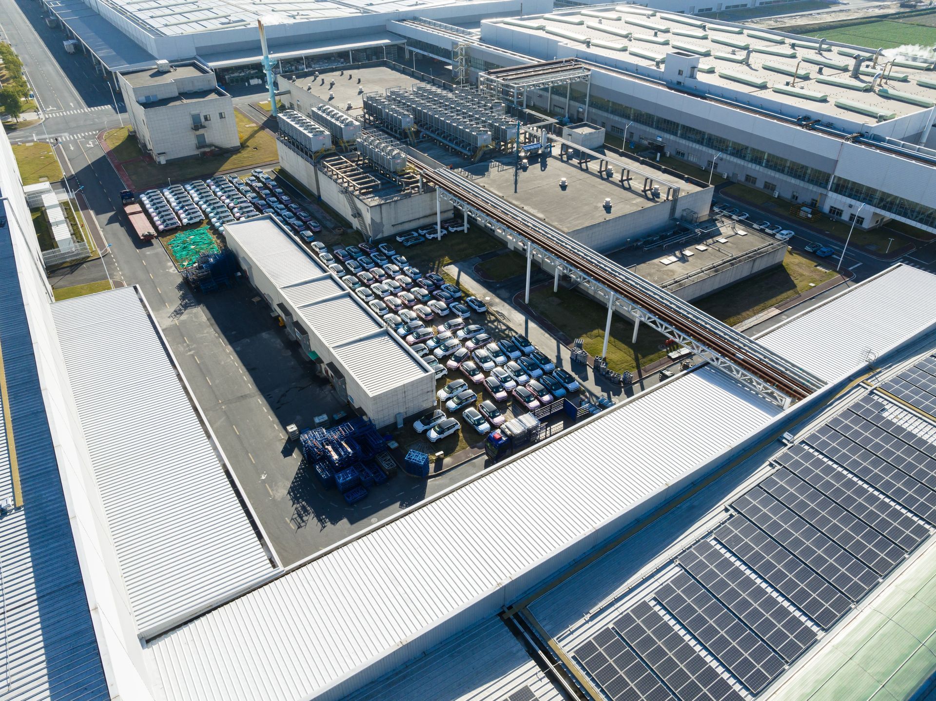An aerial view of a large building with solar panels on the roof.