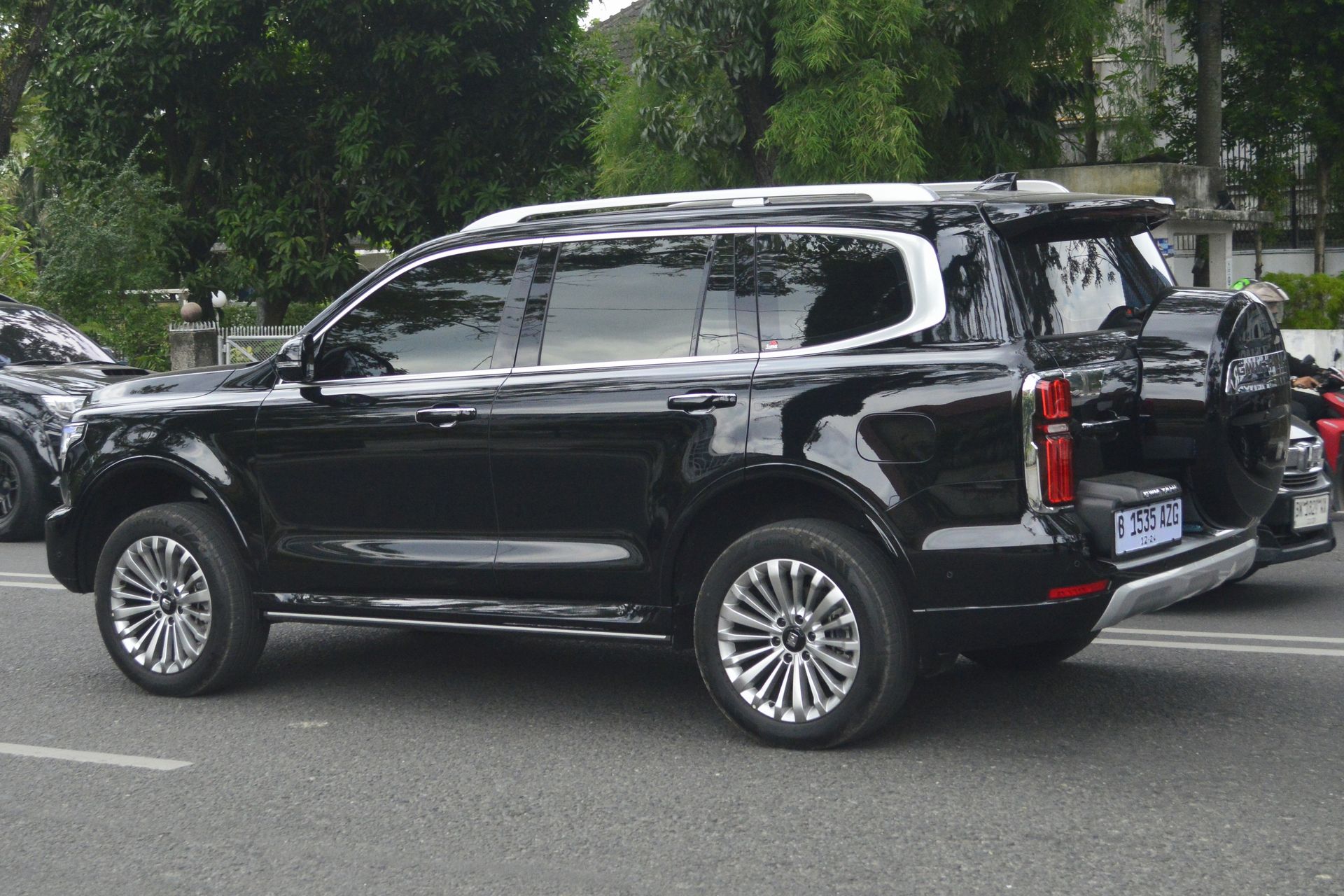 A black suv is parked on the side of the road.