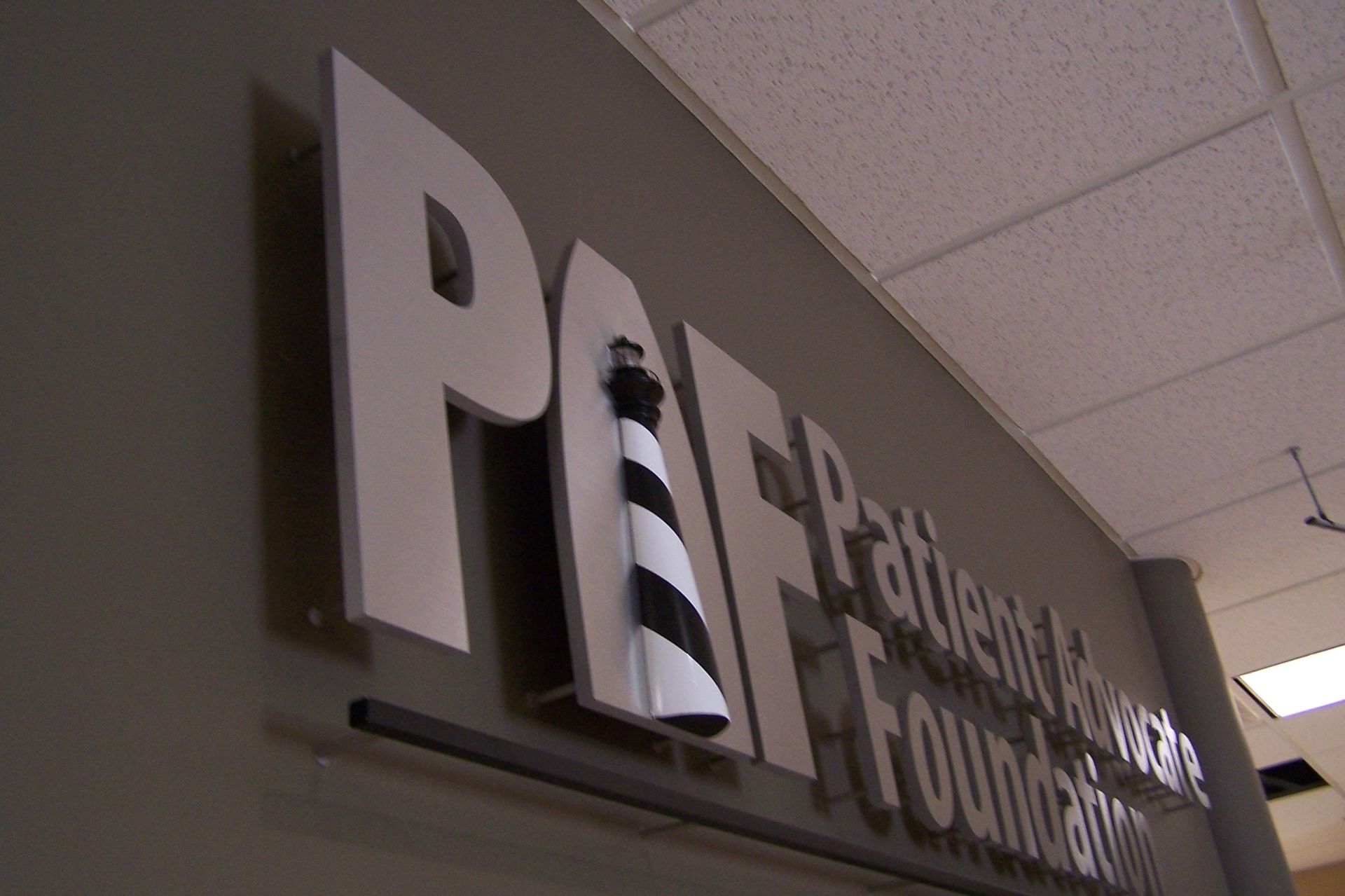 A sign for the patient advocacy foundation with a lighthouse on it