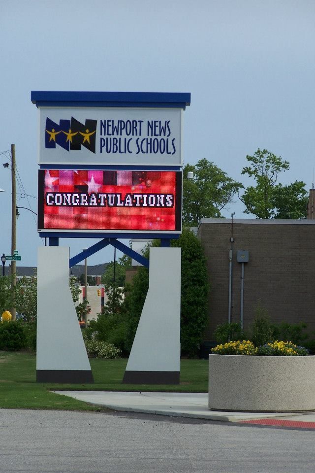 A sign for newport mens public schools says congratulations