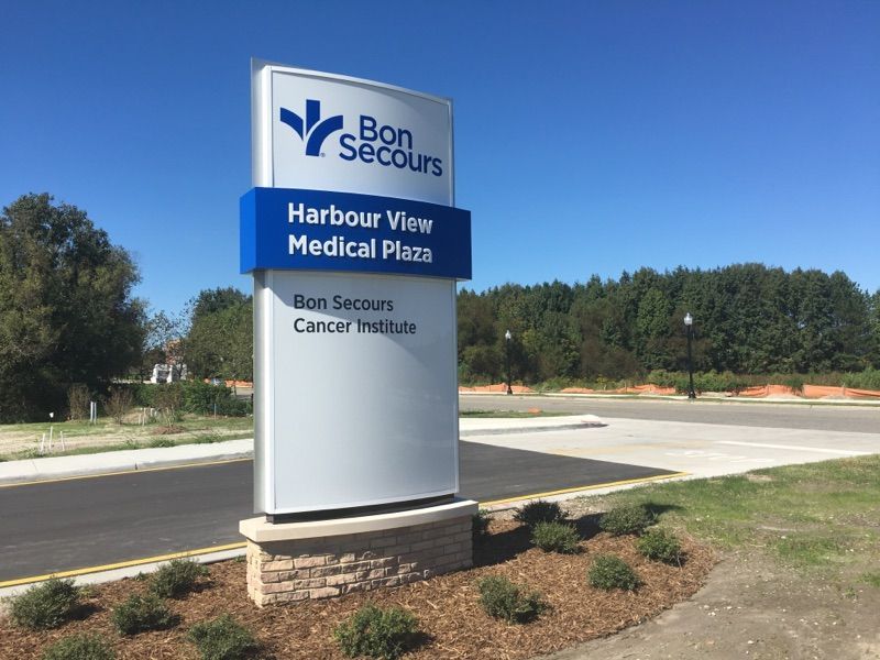 A large sign for bon secours harbour view medical plaza