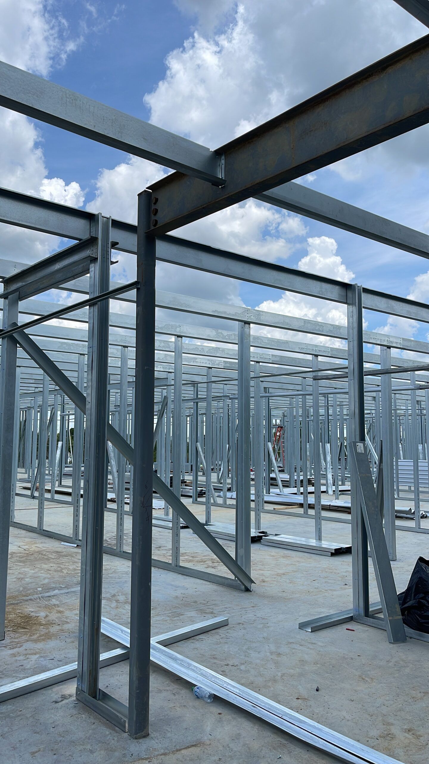 A building under construction with a blue sky in the background.