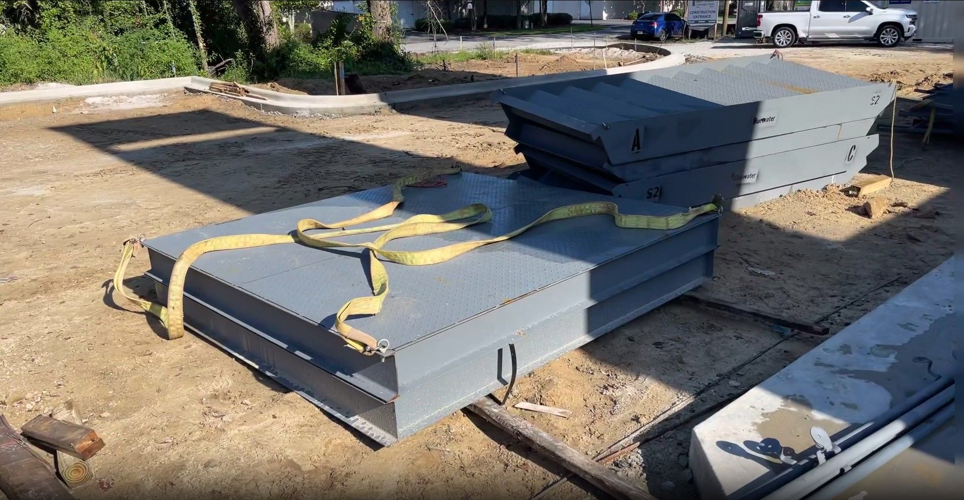 A stack of metal boxes sitting on top of each other on a dirt field.