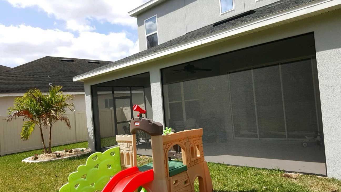 There is a slide in the backyard of a house – Valrico, FL - Salco Screens