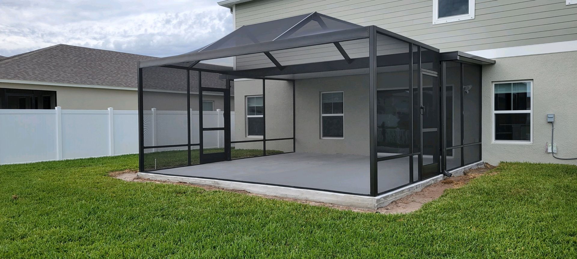 There is a Screened-in patio in the backyard of a house – Valrico, FL - Salco Screens