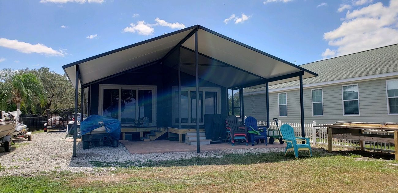 A home with a covered porch and chairs in front of it – Valrico, FL - Salco Screens