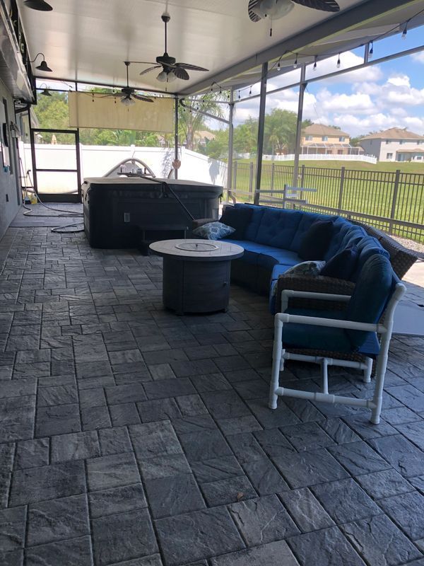 A Screened-in porch with a couch, chairs, and a table – Valrico, FL - Salco Screens