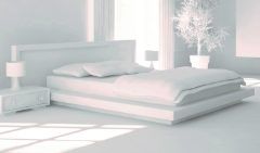 una camera da letto con biancheria in bianco