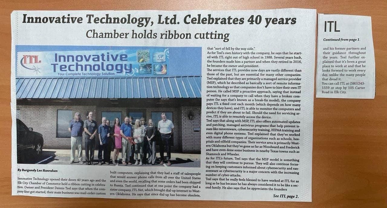 An image of a newspaper clipping showing a picture of the building and staff at Innovative Technology.