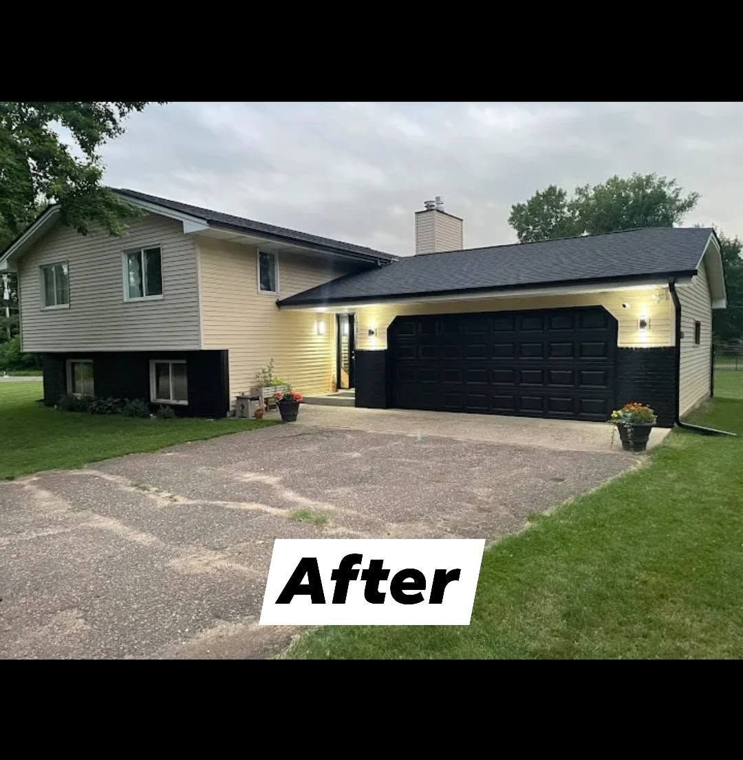 House exterior after renovation; beige and black color scheme with new garage door and lighting.