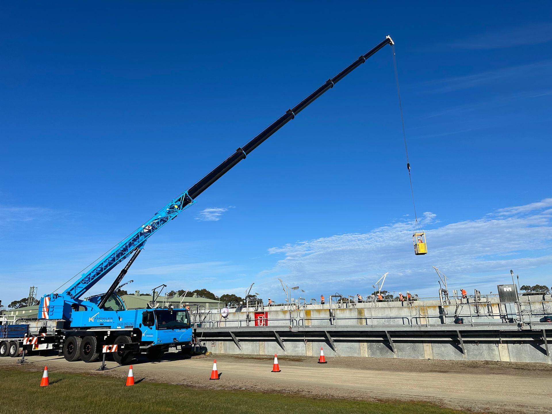 Crane lifting steel beams