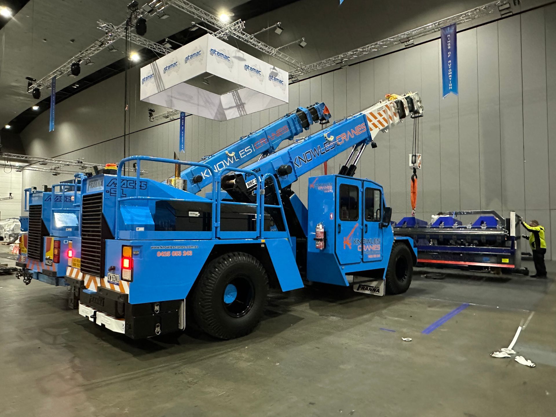 Franna and Liebherr cranes ready in warehouse for precision lifting operations