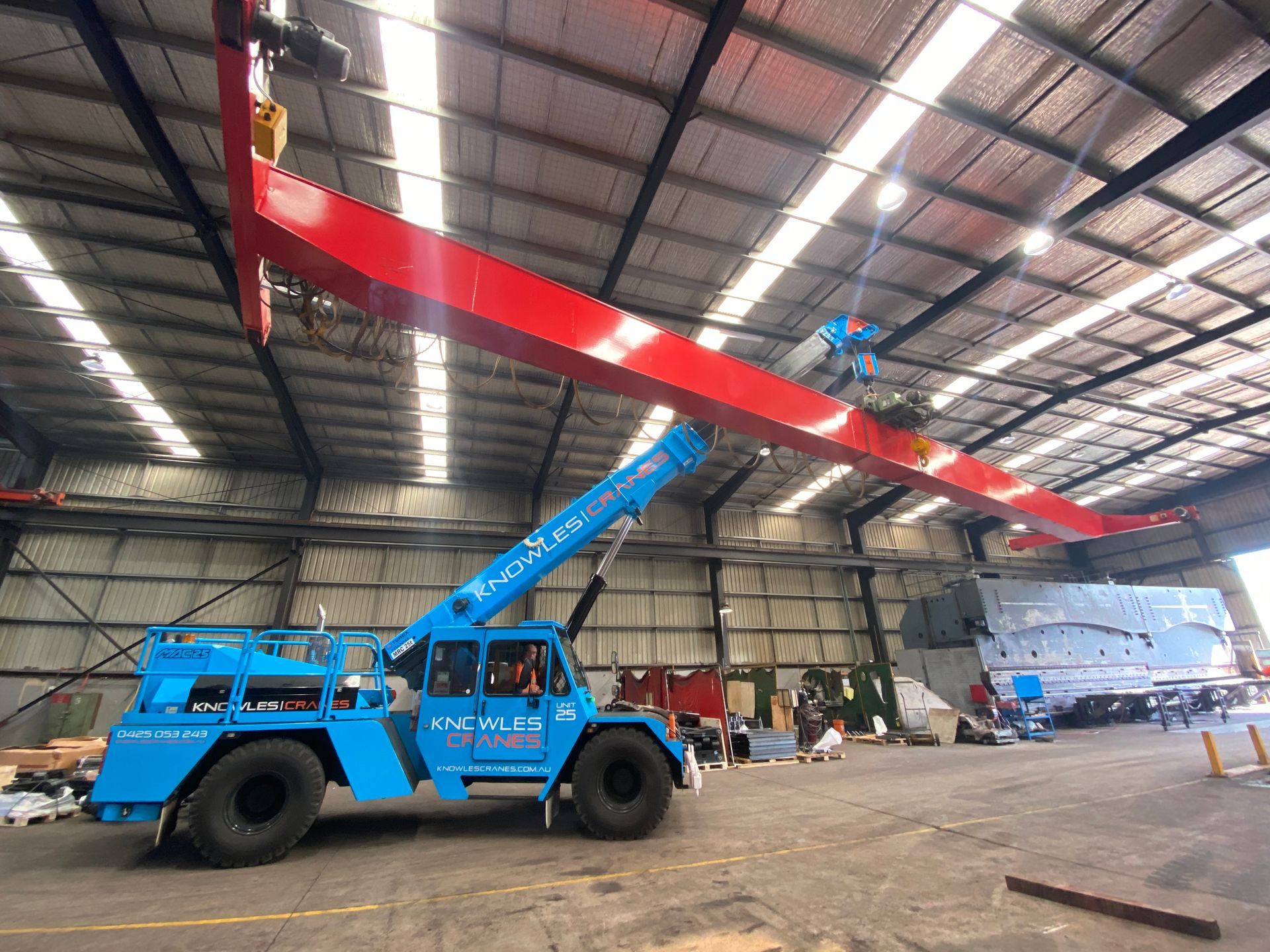 Crane lifting steel beams