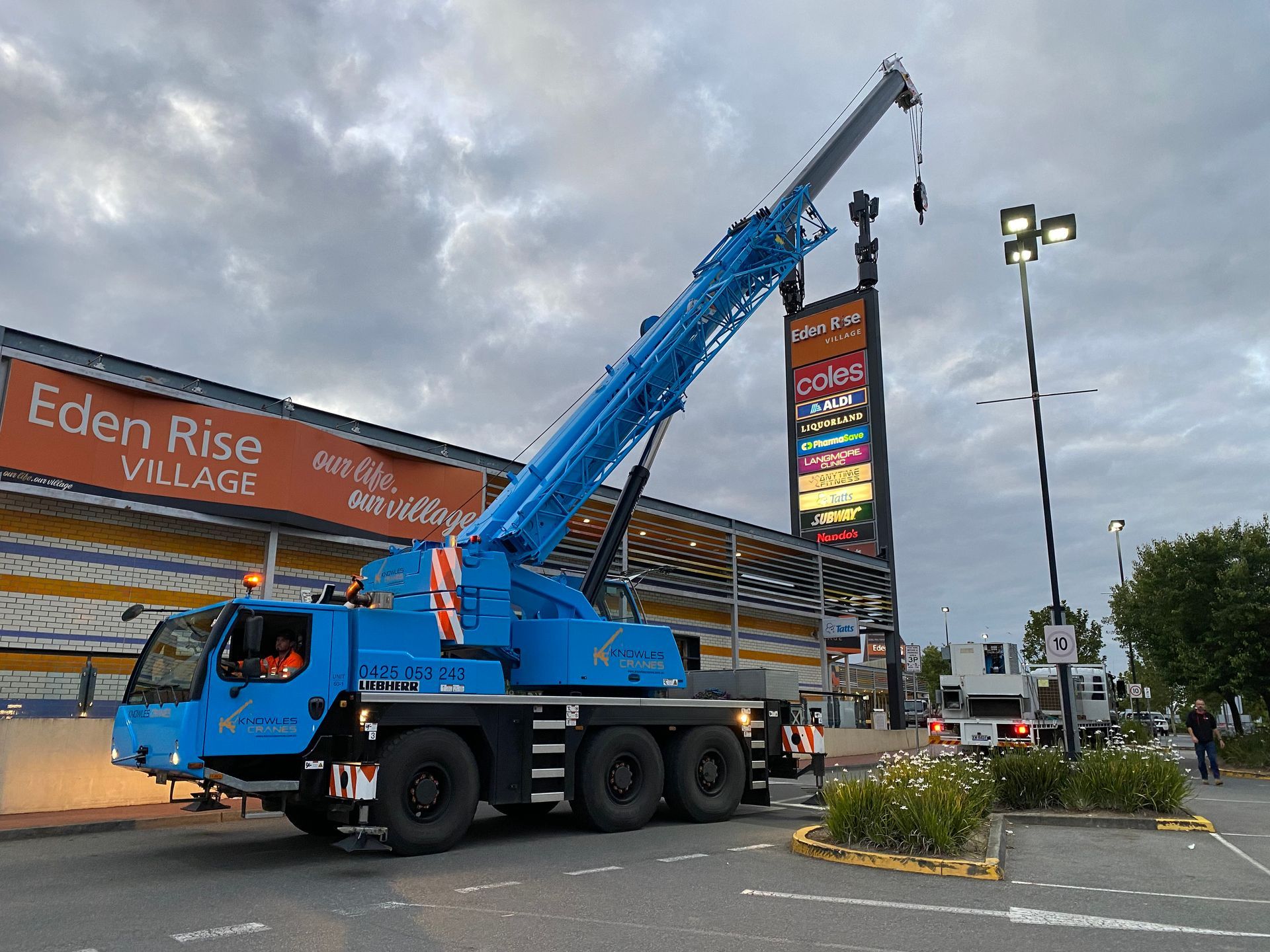 mobile crane lifting a signage
