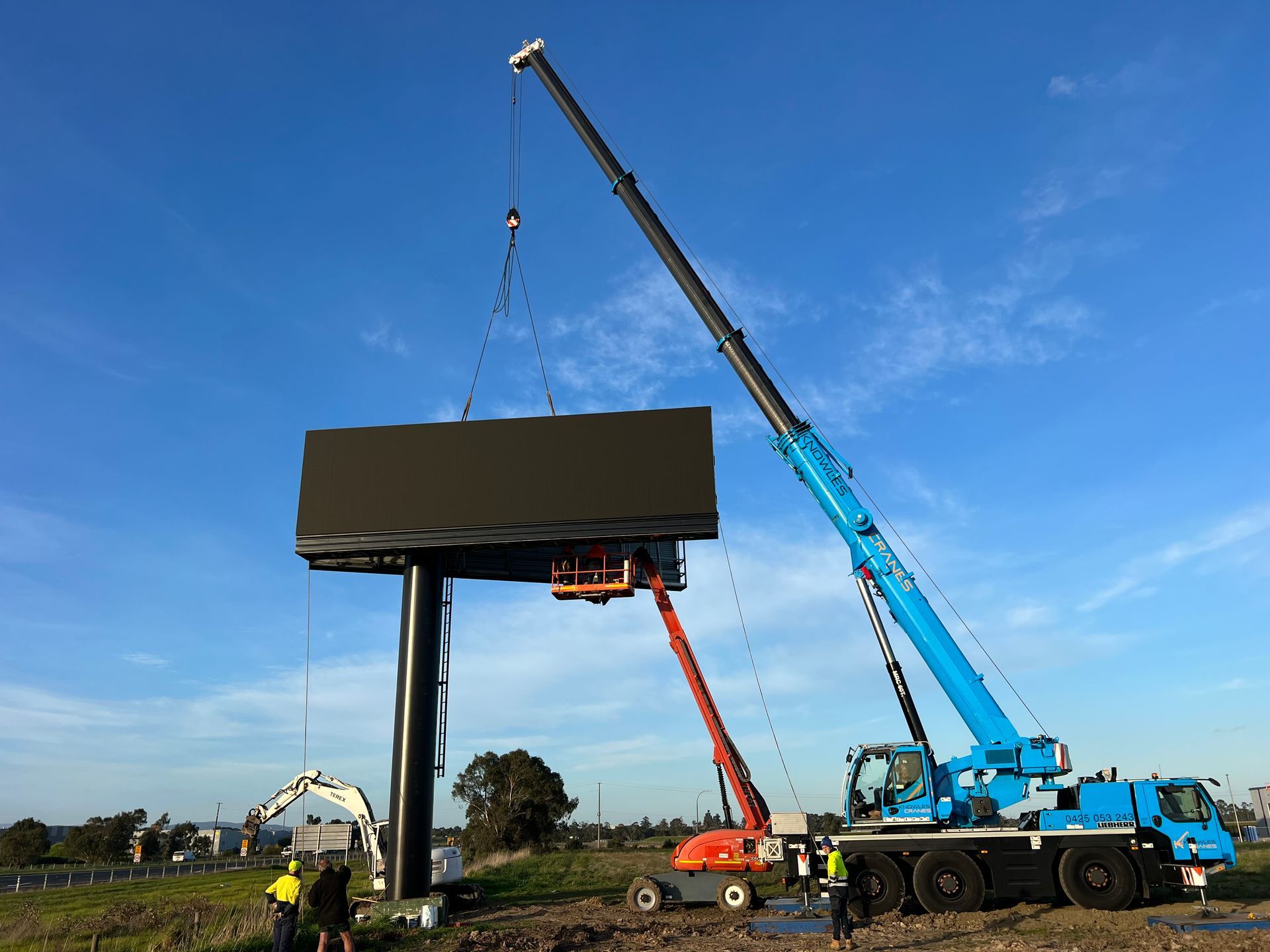 mobile crane lifting electronic billboard