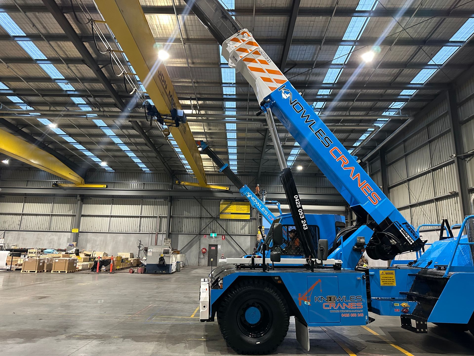 Precision lifting indoors with Knowles Cranes  installing overhead beams safely and smoothly in tight warehouse space.