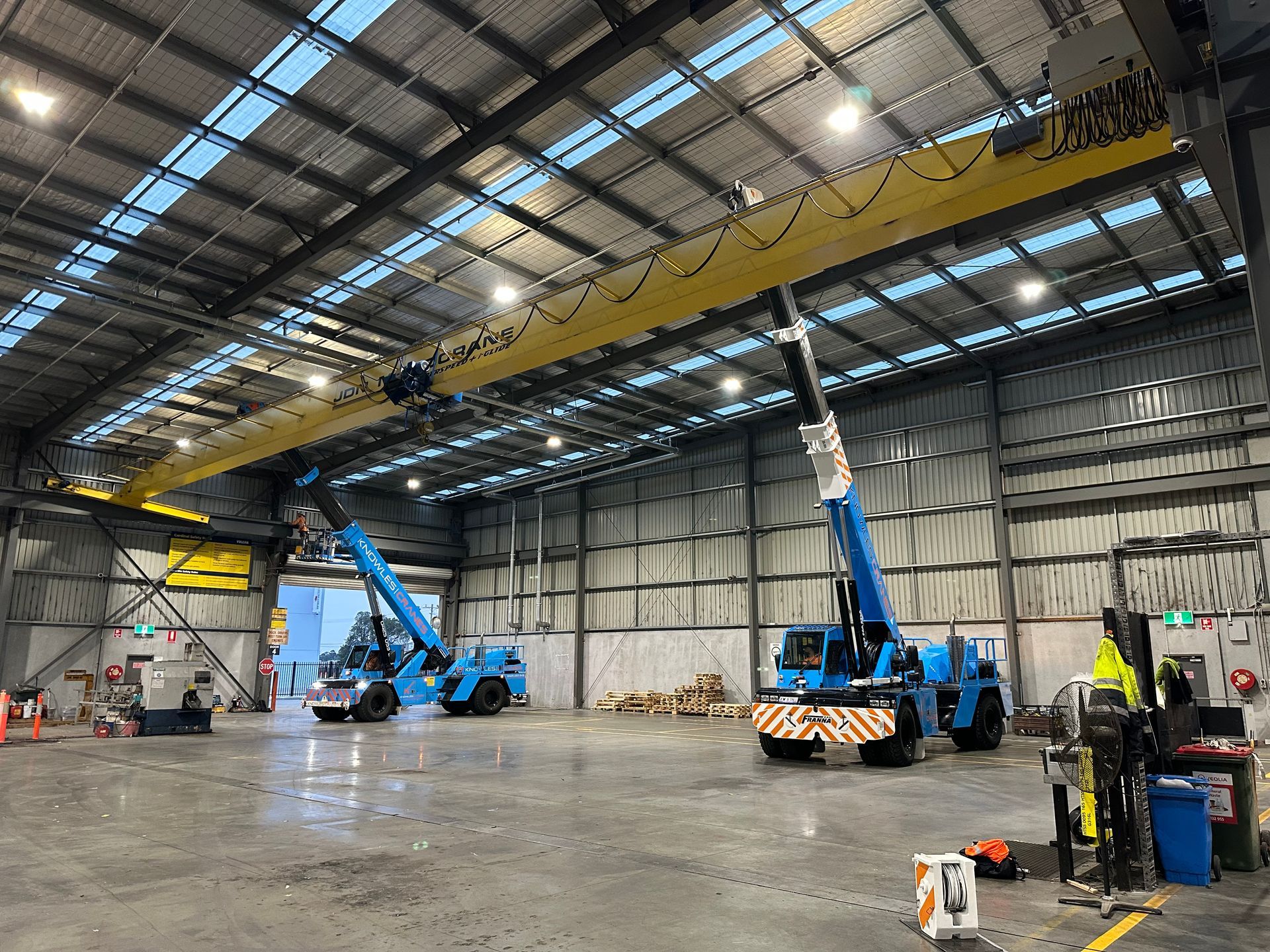 A large warehouse with a lot of machinery in it.