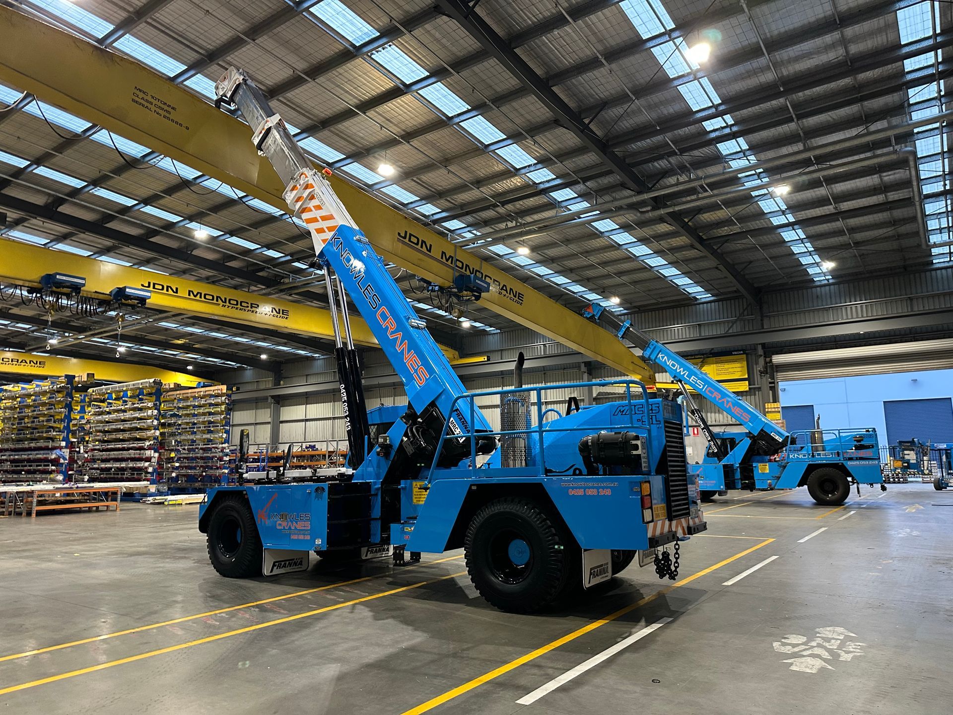 Indoor crane lift underway — Knowles Cranes handling overhead beam install with precision and safety inside the warehouse.