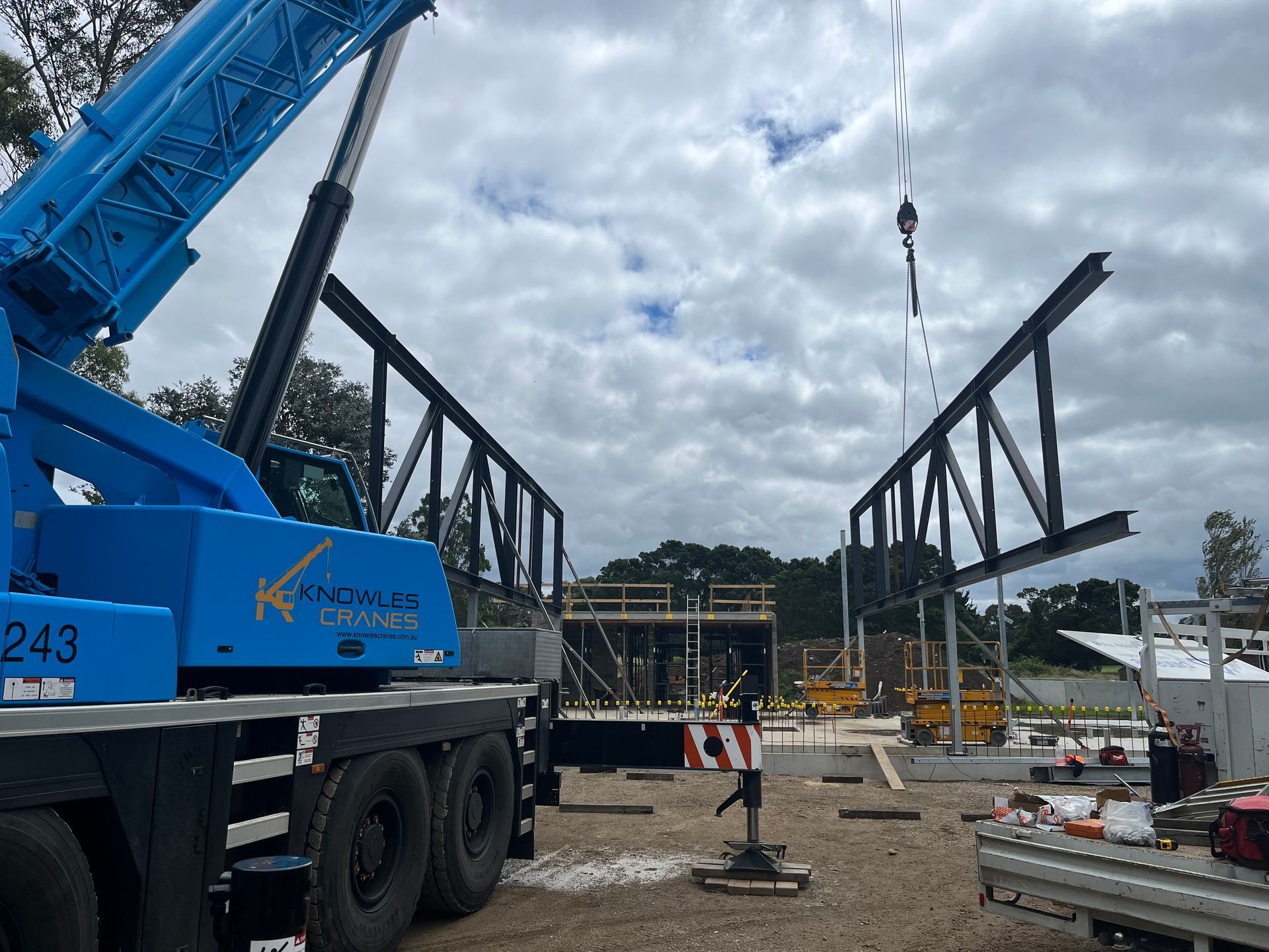 Crane lifting steel beams
