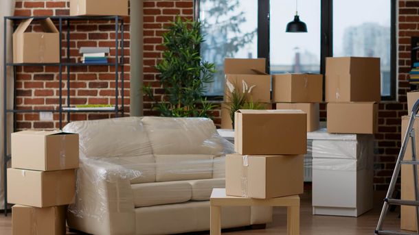 a living room filled with boxes and furniture