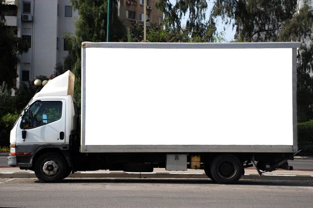 a white truck parked on the side of the road