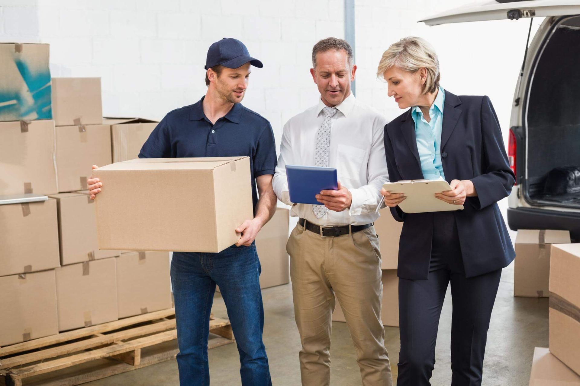 a group of people standing in a warehouse with boxes