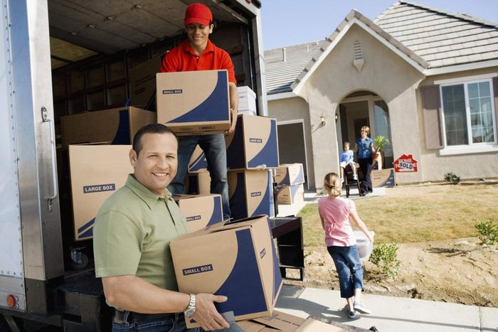 a man standing in the back of a moving truck