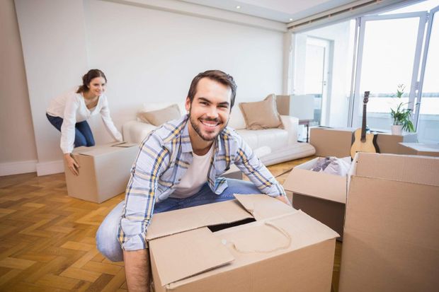 a man sitting on the floor with a box in front of him