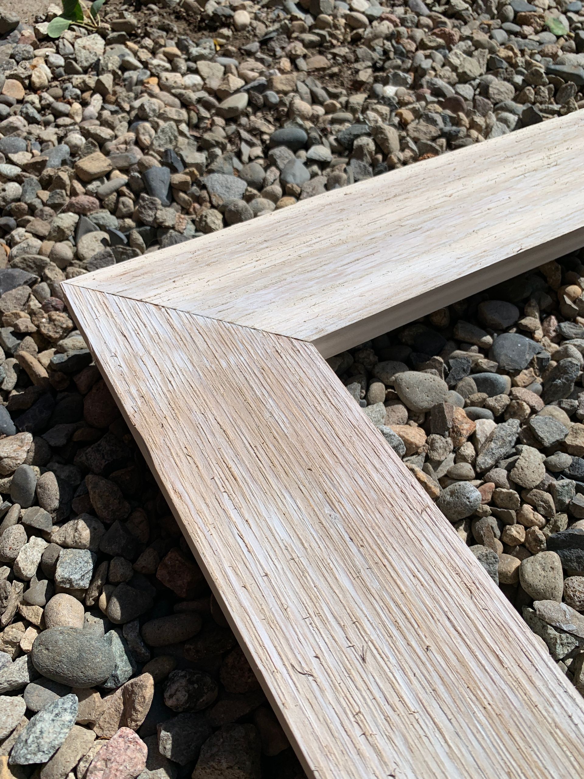 A piece of wood is sitting on top of a pile of rocks.