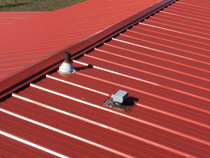 A red roof with a chimney on it