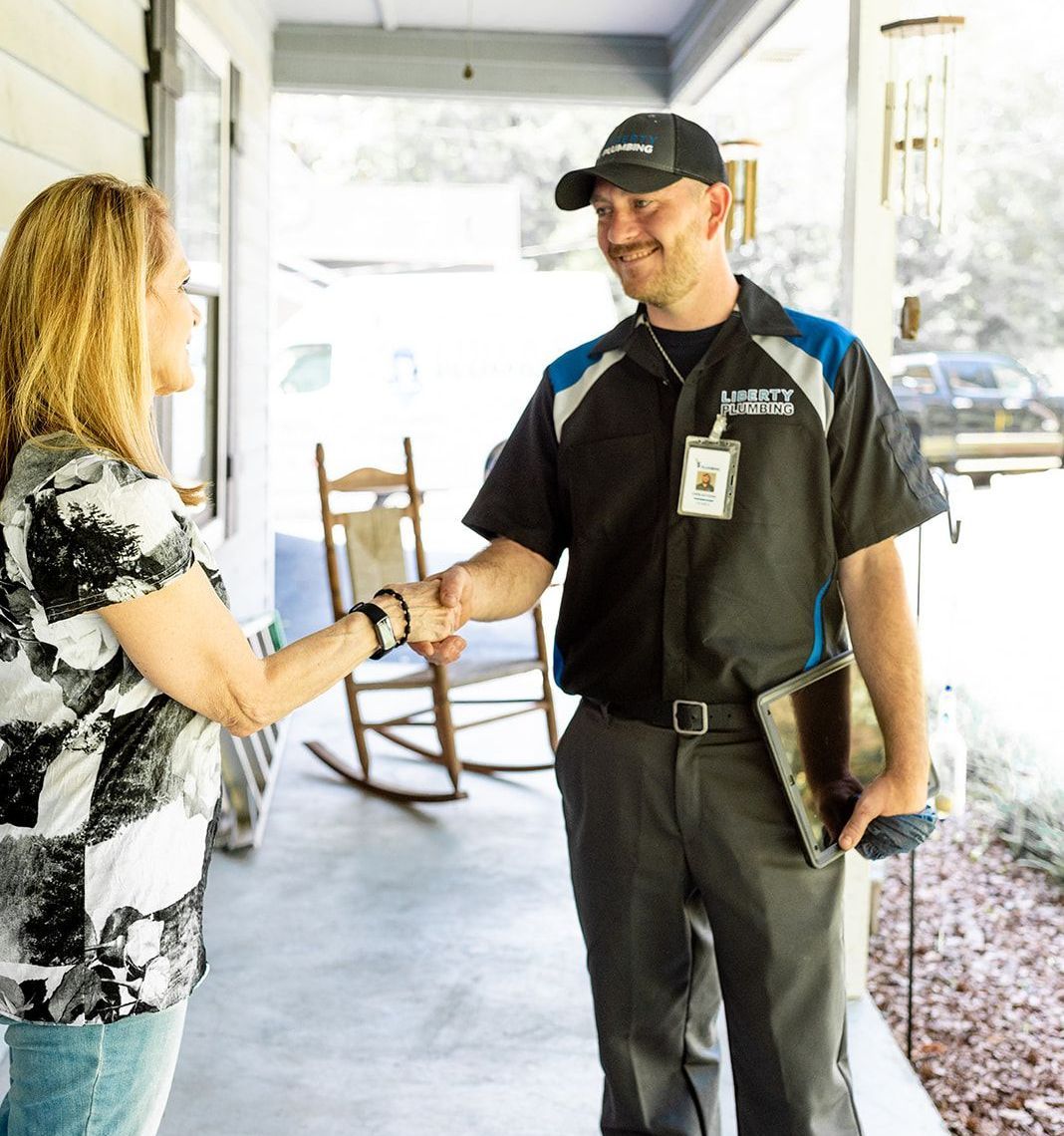 A man shaking hands with a woman on a porch