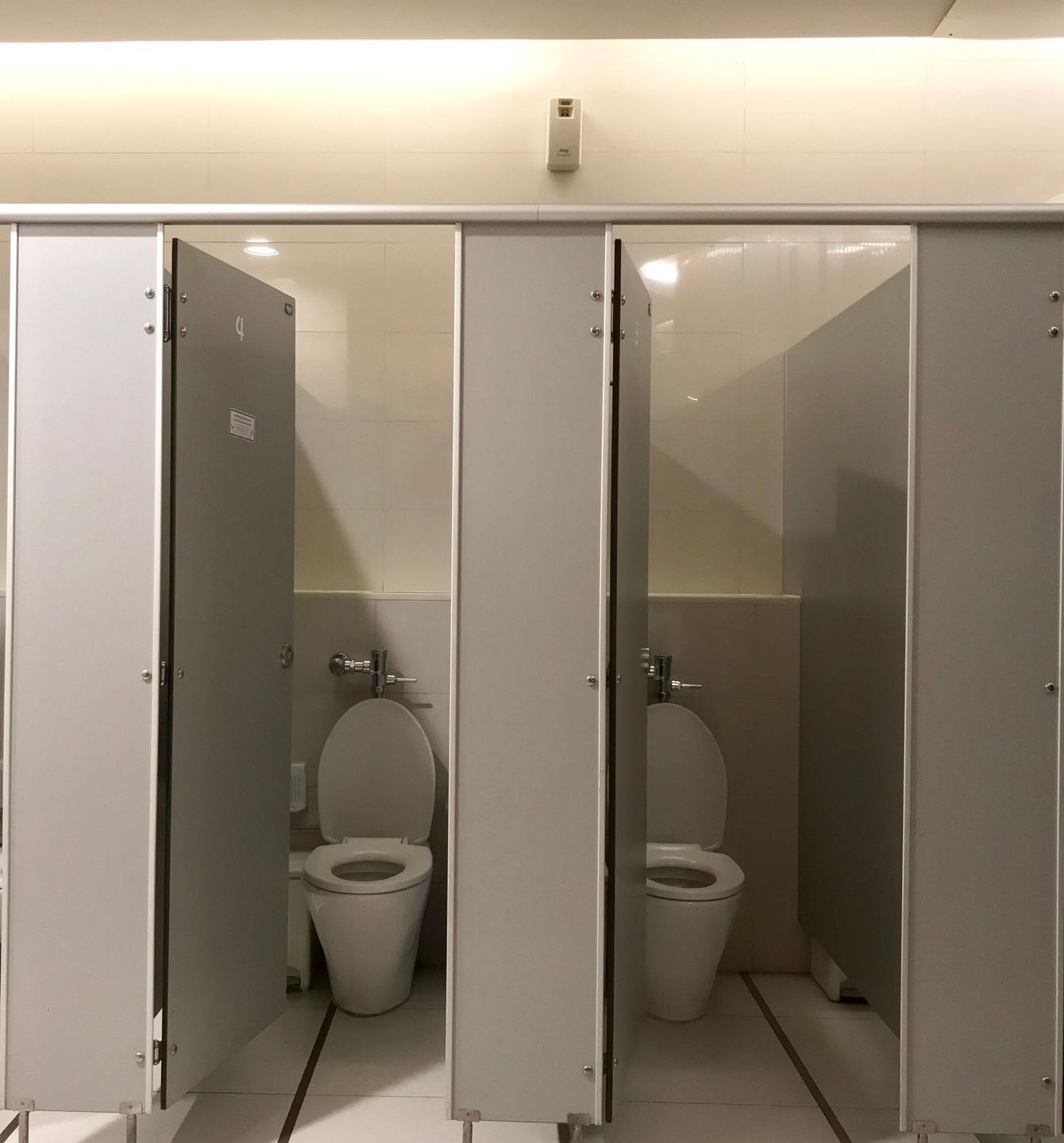 A row of toilets in a public restroom