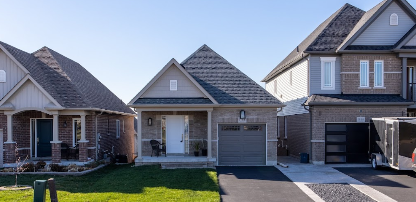 A row of houses with a trailer parked in front of them.