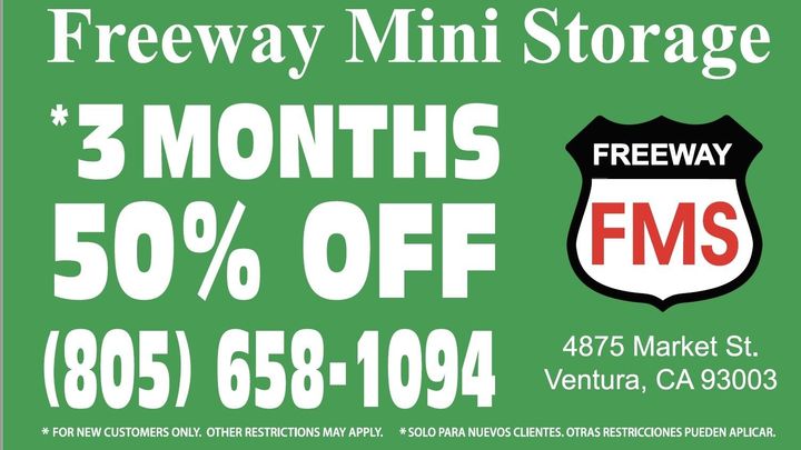 A green sign that says ' freeway mini storage ' on it A green sign that says ' freeway mini storage ' on it