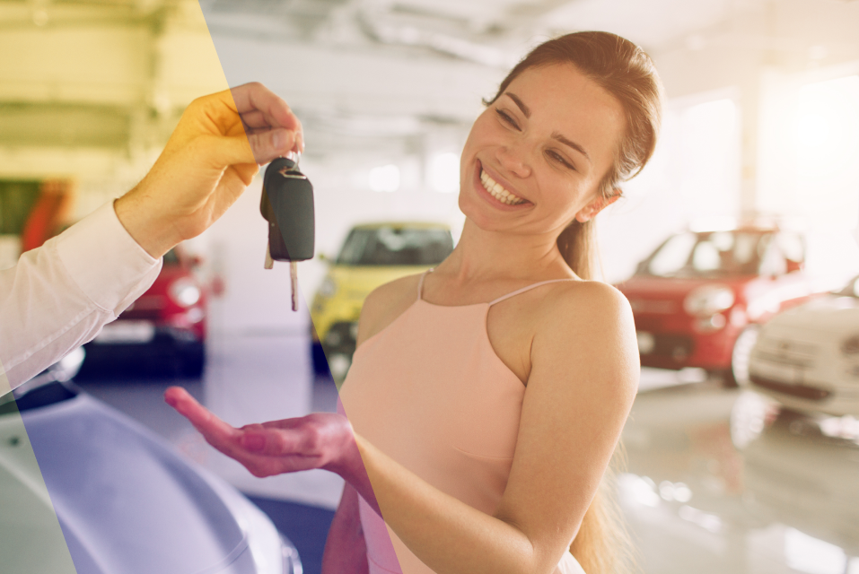 Person smiles as hand gives her car keys at a dealership. | St. Louis Auto & Truck Repair