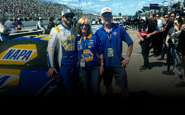Race car driver with two fans next to the NAPA-sponsored car at a track. | St. Louis Auto & Truck Repair