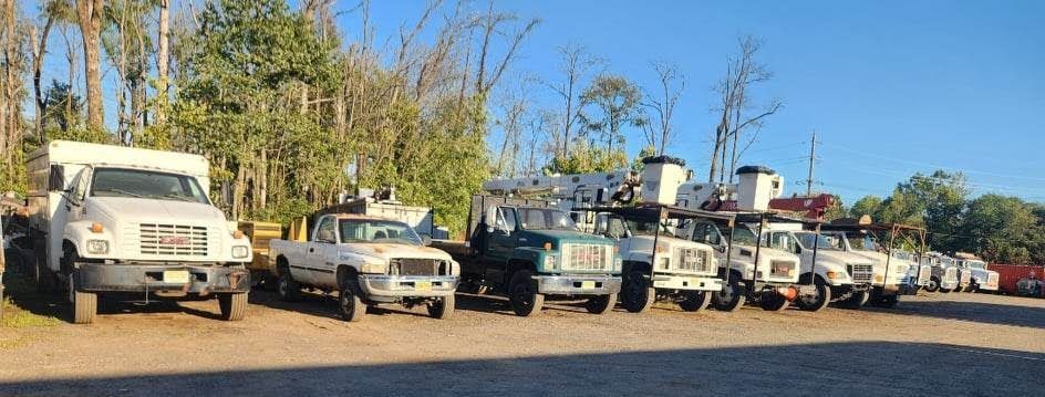 A Row of Trucks Parked Next to Each Other in A Parking Lot – Lawrence Township, NJ – Carroll Tree Service