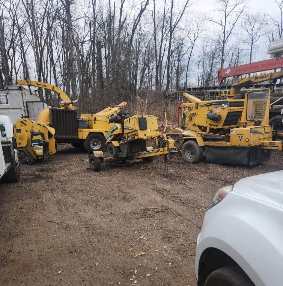 A Bunch of Construction Vehicles Are Parked in A Dirt Lot – Lawrence Township, NJ – Carroll Tree Service