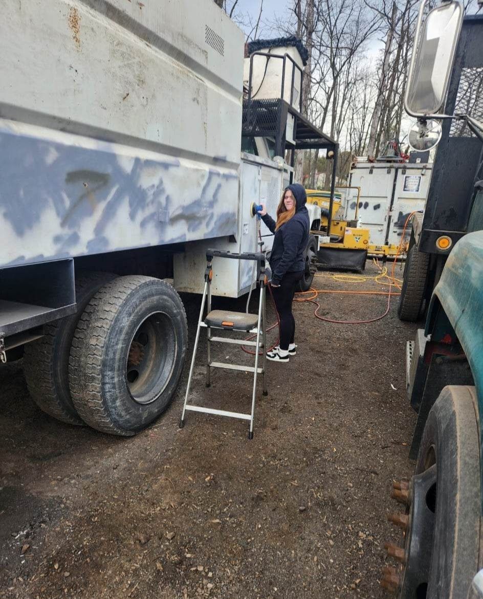 A Woman Standing on A Ladder Next to A Truck – Lawrence Township, NJ – Carroll Tree Service